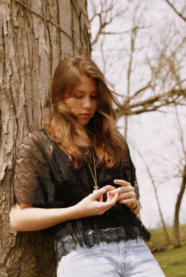 cute flat brunette against a tree