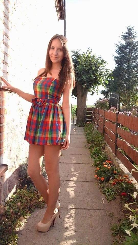 Blonde babe in colorful mini dress outdoors