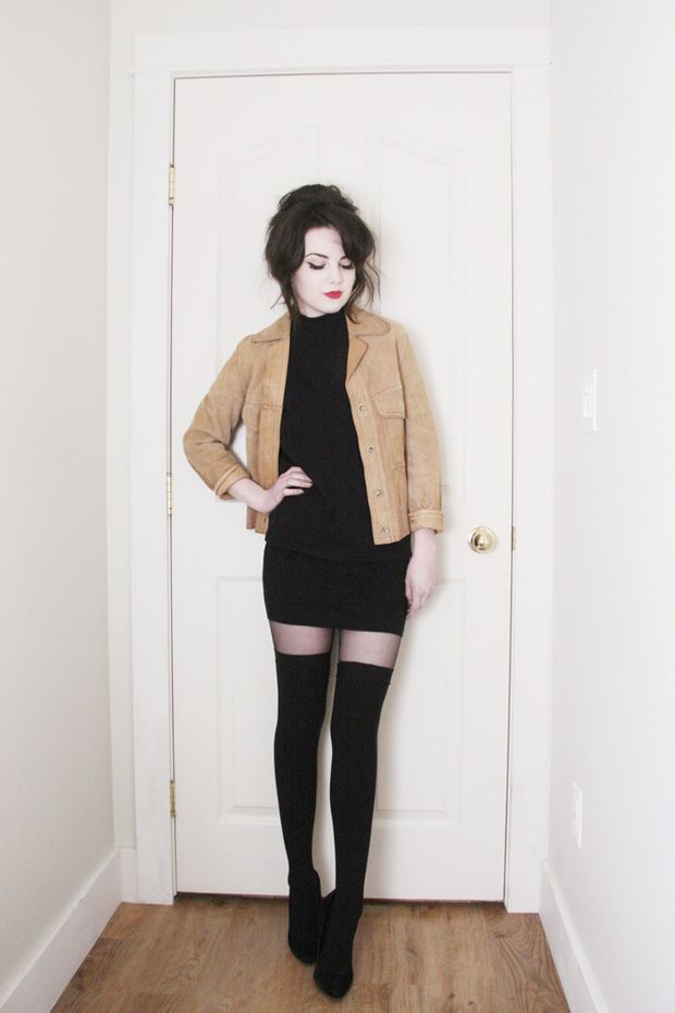 pale hipster posing fully clothed in front of door