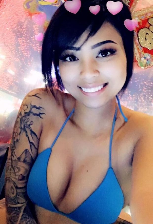 Hot asian showing cleavage and tattoo