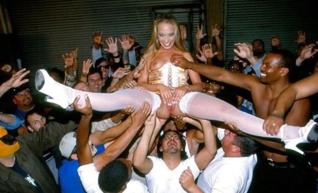 She is crowd surfing naked and groped by everyone.