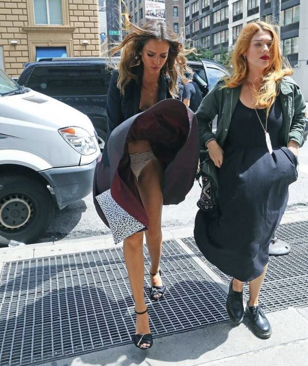 Jessica Alba upskirt wardrobe malfunction accidentally flashing her panties when her dress completely flies up seen by paparazzi.