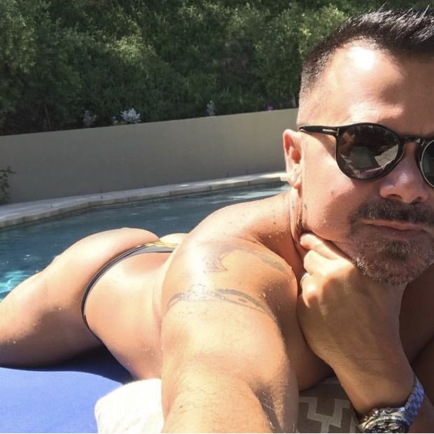 Gay man in thong tanning ass