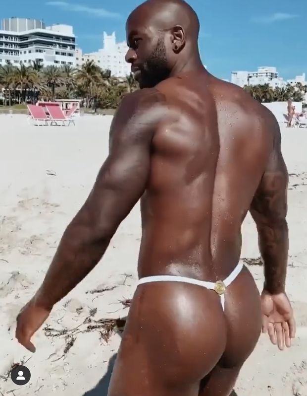 Fit gay guy in thong on the beach