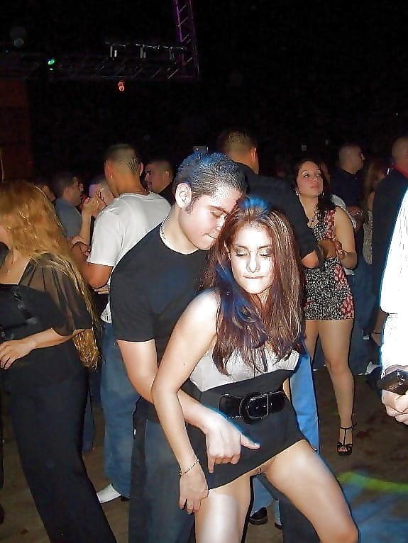 He's flashing her pussy on the dance floor.