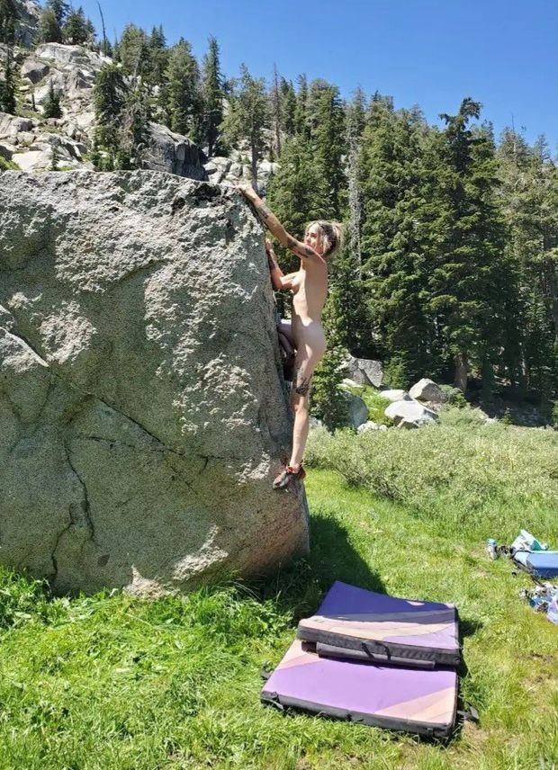 Nude bouldering. Climbing rock