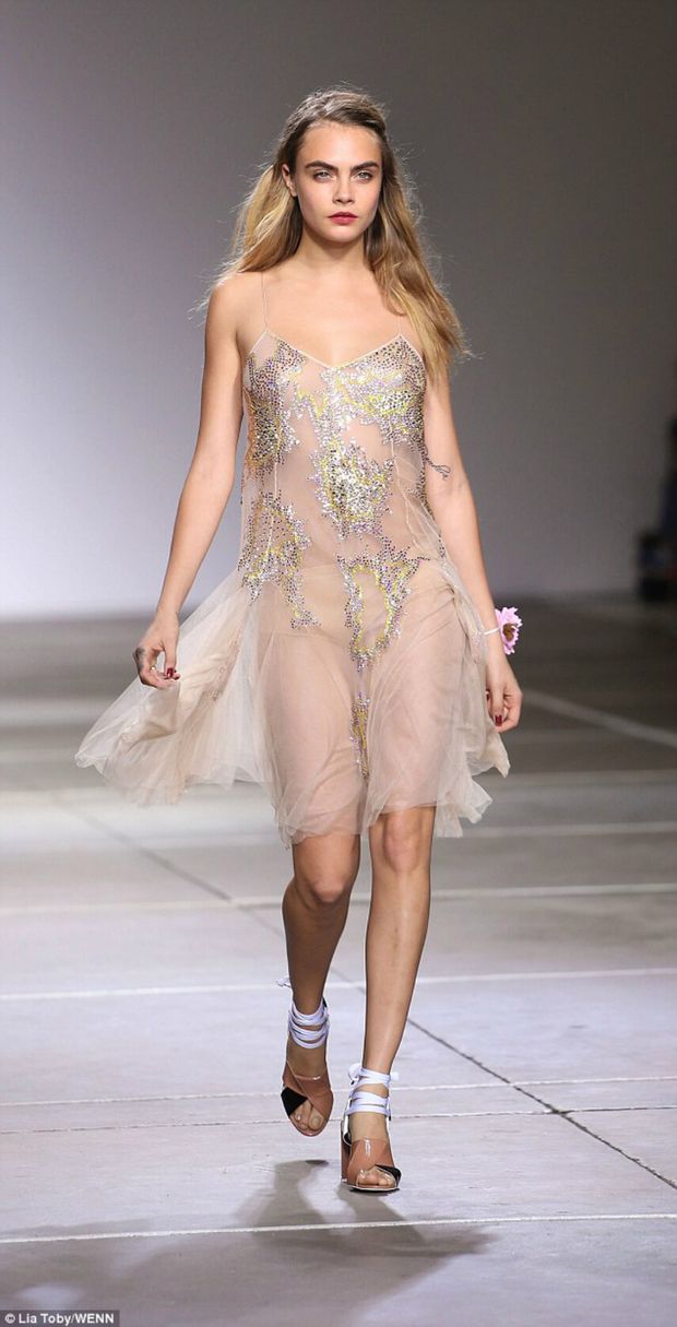 Cara Delevingne modeling a see thru dress, nude underneath.