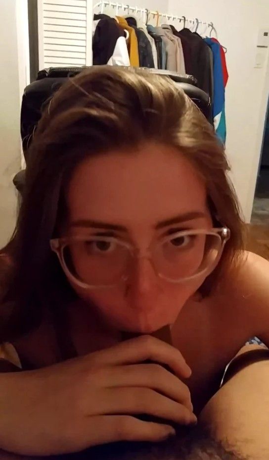 Amateur brunette in glasses sucking on some cock