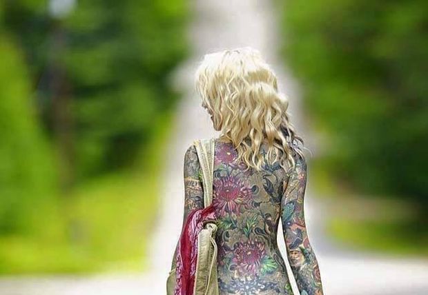 Blonde with full beautiful full body tattoo walking