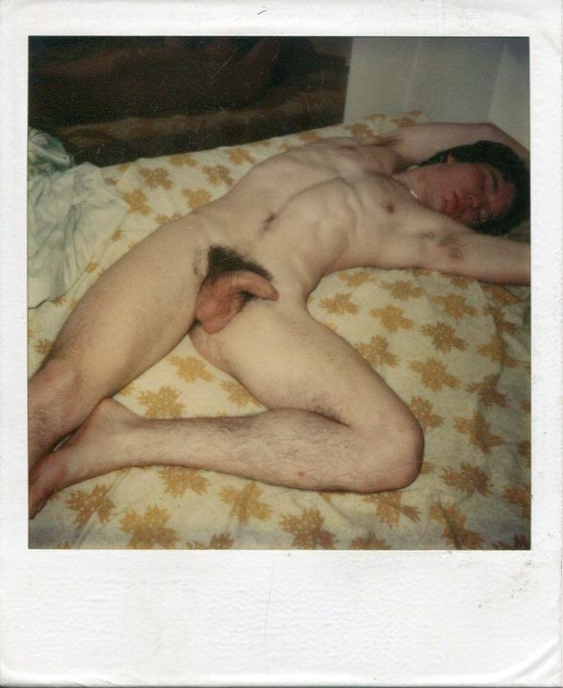 Nude male slut sprawled on a bed