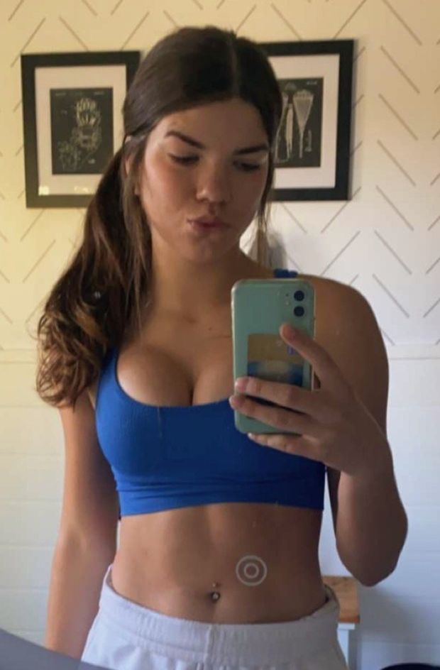 Brunette blue sports bra selfie