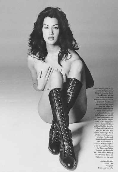 Yasmeen Ghauri wearing high lace up boots, and nothing else (B&W)