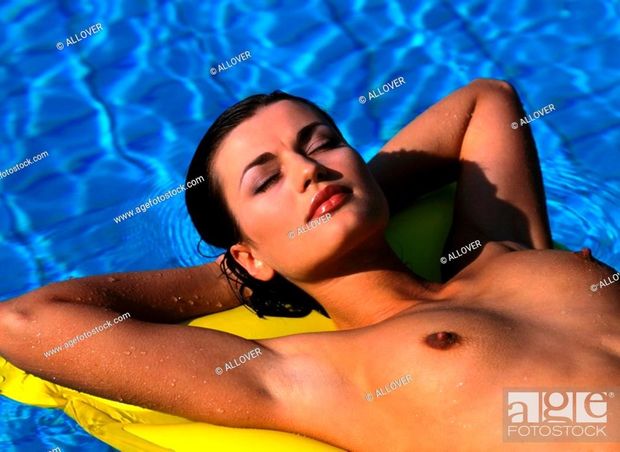 Classy topless woman sunbathing