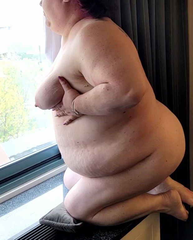 BBW naked in hotel room window flashing her tits and belly