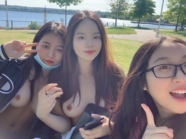 Cute Asian flashing in the park