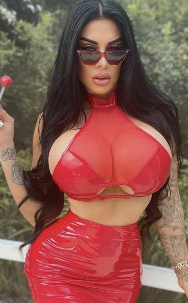 Pretty busty brunette red leather skirt & top & shades...